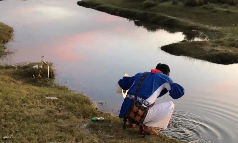 Persona en la orrilla de un río